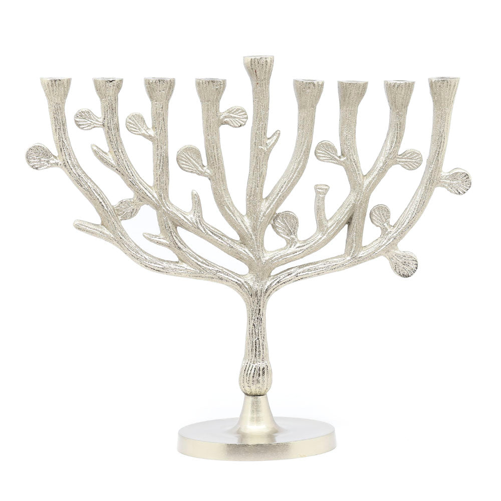 A silver aluminum menorah with a tree of life design, handcrafted in India.