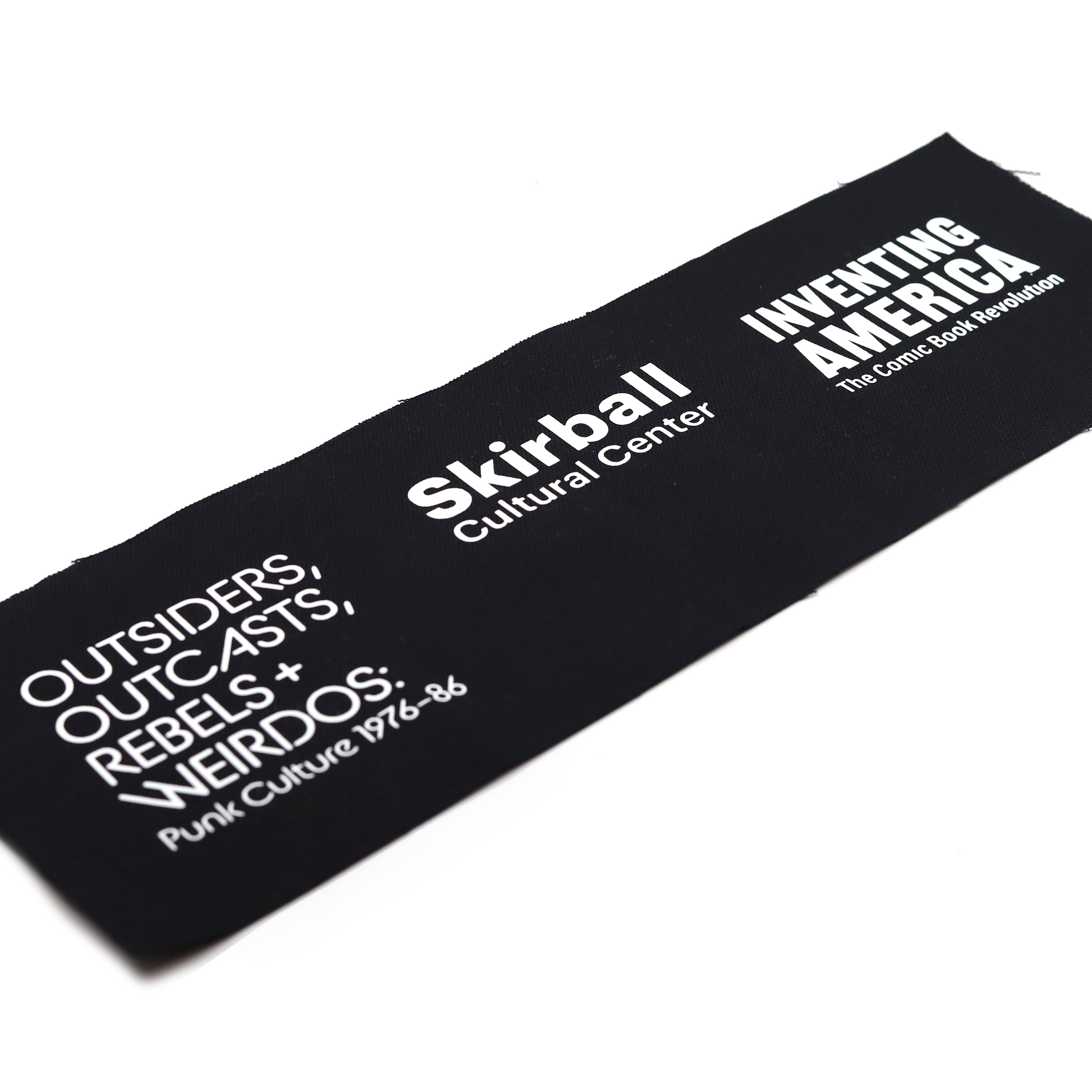 Black rectangle of fabric with white text featuring Skirball Cultural Center and event names