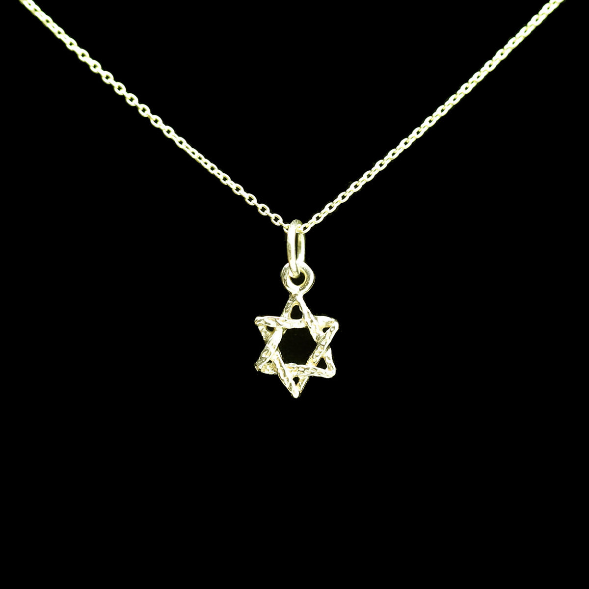 A gold Star of David pendant necklace on a delicate gold chain, shown against a solid black background.